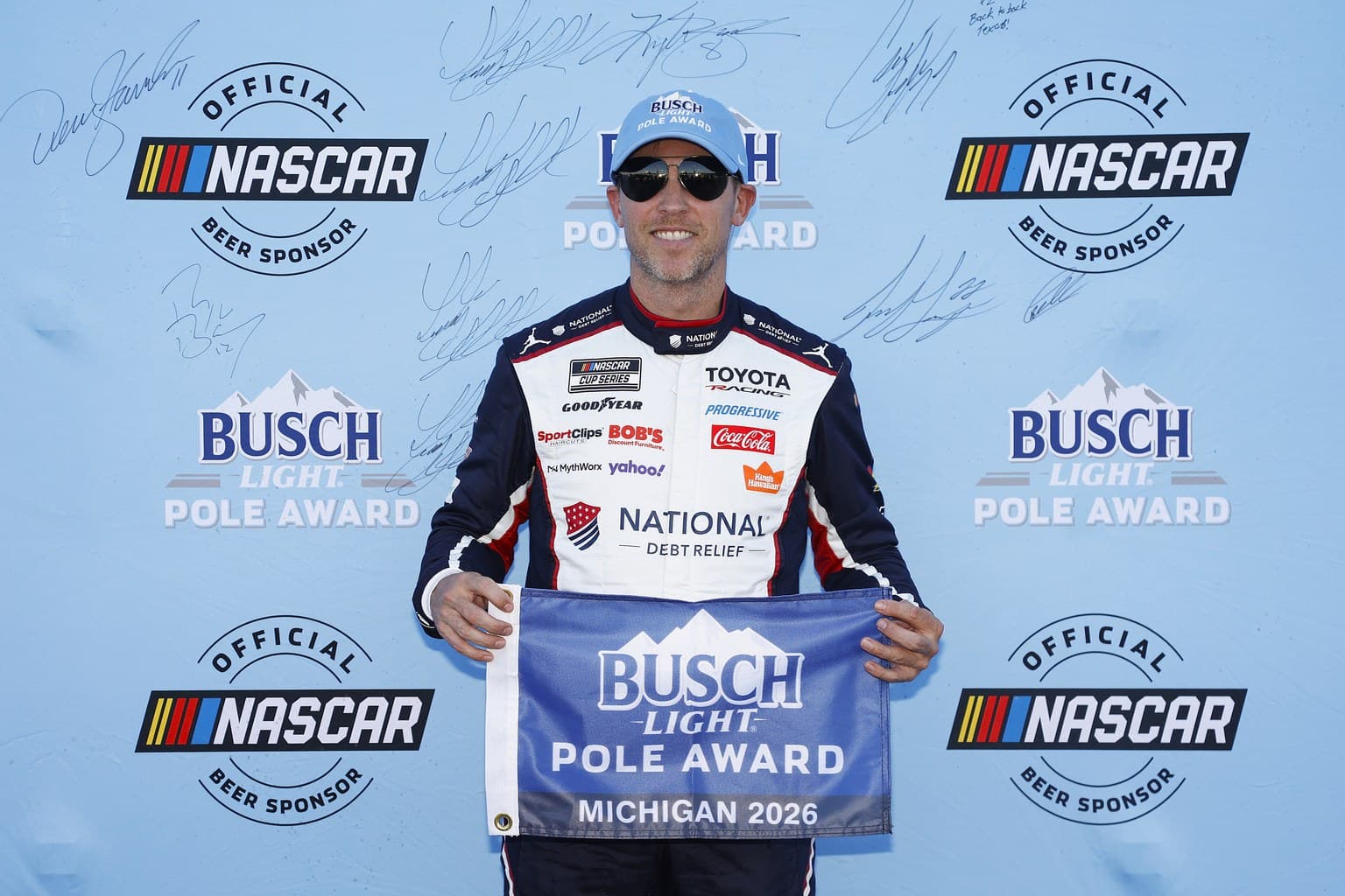 Denny Hamlin poses after winning the pole award during qualifying for the NASCAR Cup Series FireKeepers Casino 400 at Michigan International Speedway.